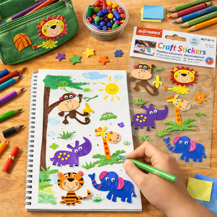 Child coloring with craft stickers on a wooden table