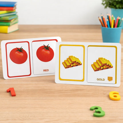 Educational card game with tomato and gold images on a wooden table