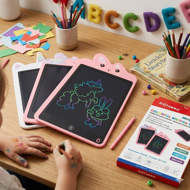 Children's drawing tablets with colorful pencils and stationery on a table.