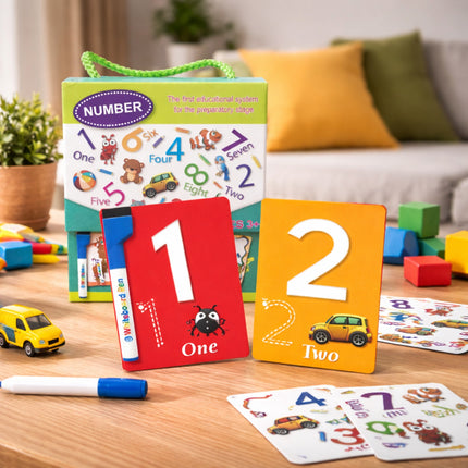 Educational number cards and toys on a table with a couch and plants in the background