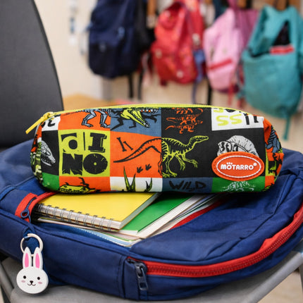 Colorful pencil case with dinosaur design on a backpack with books