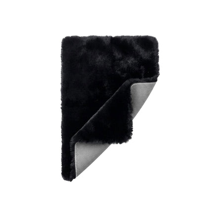 Black fur blanket with gray mesh backing on a white background