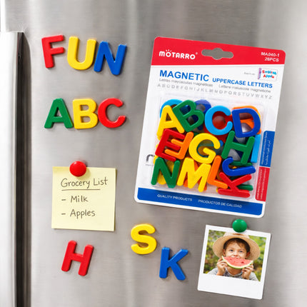 Magnetic uppercase letters on a refrigerator with a package of letters and a photo.