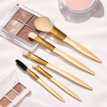 Makeup brushes and palettes on a white surface