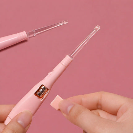 Pink electronic device with clear components held by a hand against a pink background