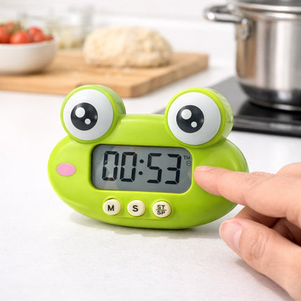 Green frog-shaped timer on a kitchen counter with a hand pressing a button.