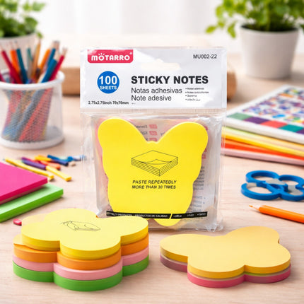 Packaged sticky notes with colorful cloud shapes on a desk with stationery items.