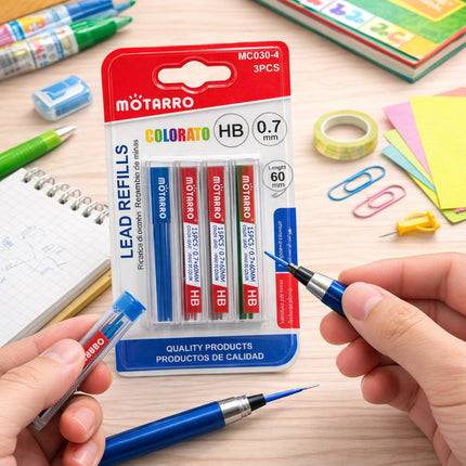 MOTARRO lead refills packaging with a hand holding a blue pencil on a desk with stationery items.