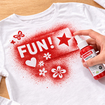 White t-shirt with red and white designs being sprayed with a bottle of Rotoro textile dye.