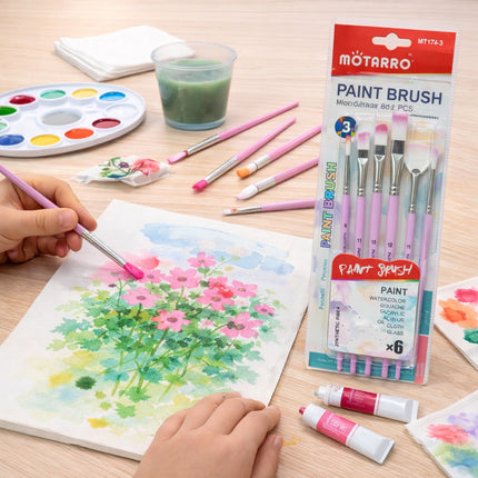Children painting flowers with Motarro paintbrushes on a wooden table.