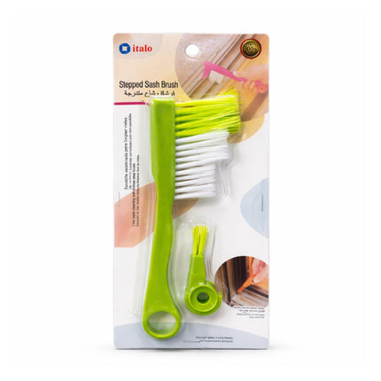 Packaged stepped sash brush with green handle and white bristles on a white background