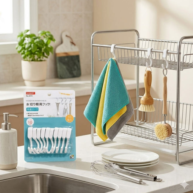 Packaging of dishwashing brushes on a kitchen counter with a dish rack and cleaning tools in the background.