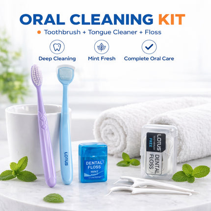 Oral cleaning kit with toothbrush, tongue cleaner, and floss on a white surface with mint leaves.