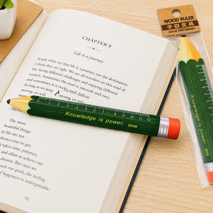 Wooden ruler with pencil design on an open book