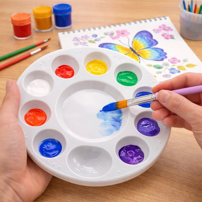 Person painting on a palette with colorful paints and a butterfly illustration in the background.