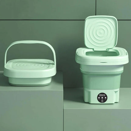 Collapsible green toilet and basket on a gray surface with a green background