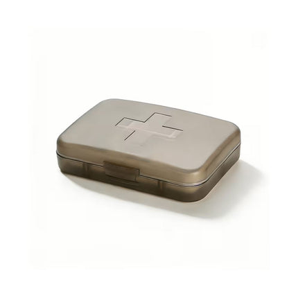 Metallic pill box with a cross symbol on a white background
