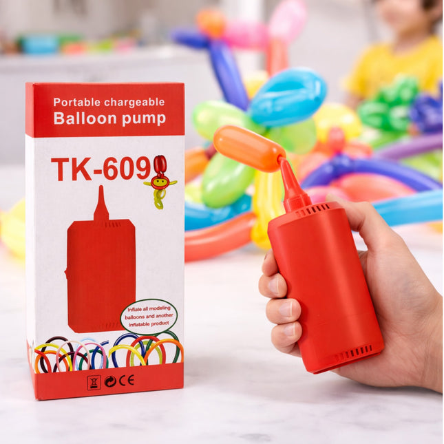 Red portable balloon pump with packaging and colorful balloons in the background
