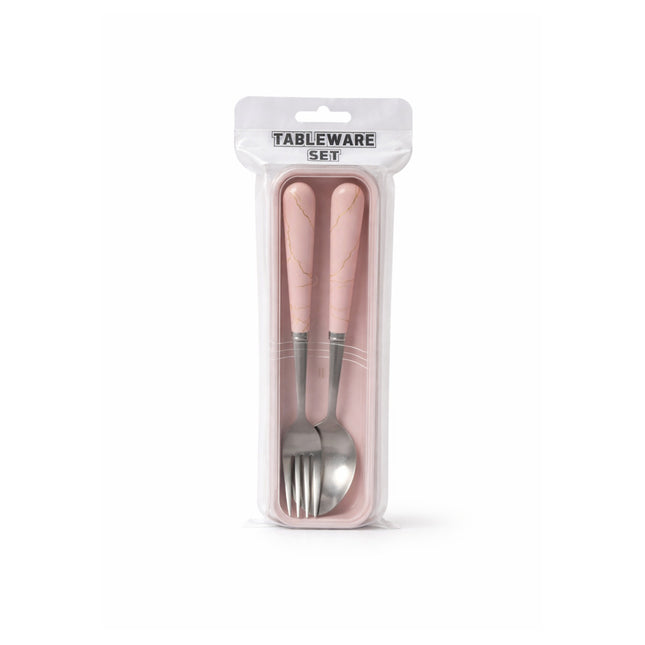 Packaged tableware set with pink handles on a white background