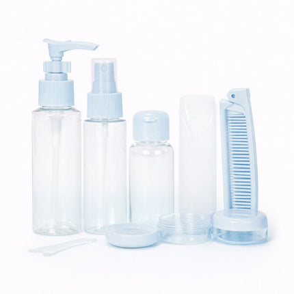 Set of clear plastic bottles with blue caps and accessories on a white background