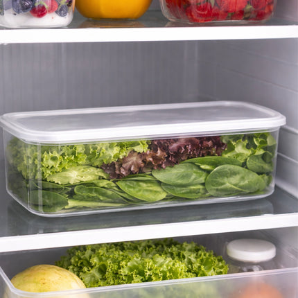 Clear containers with salad greens inside a refrigerator.