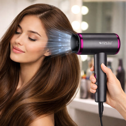 Woman using a hair dryer with visible branding in a bathroom setting