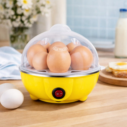 Yellow egg cooker with six brown eggs on a wooden surface.