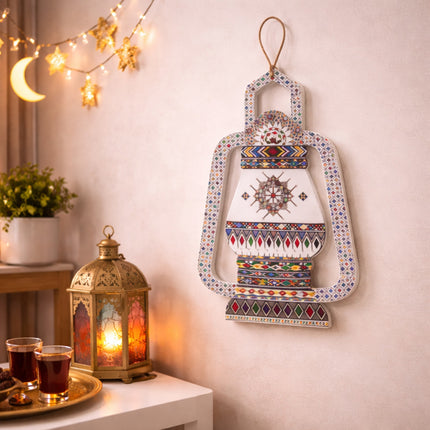 Decorative lantern hanging on a wall with a small table and lanterns in the foreground.