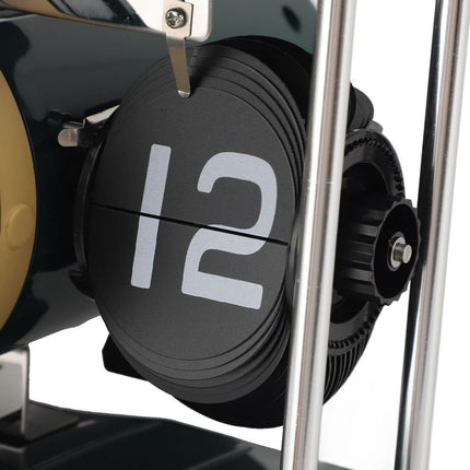 Close-up of a mechanical clock with the number 12 on a white background