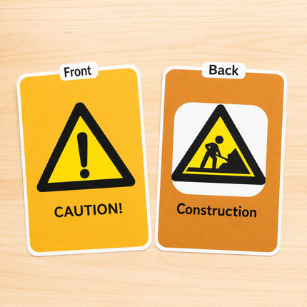 Two signs showing front and back views of a caution and construction warning symbol.