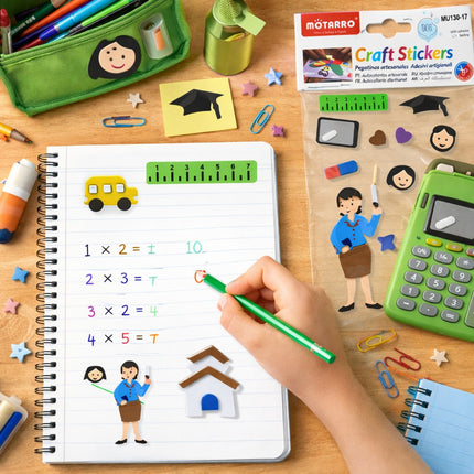 Educational materials including a notebook with math illustrations, a calculator, and craft supplies on a wooden surface.