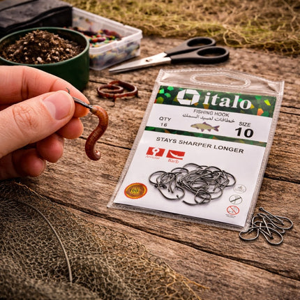 Fishing hook with a package of Italo fishing hooks on a wooden surface.