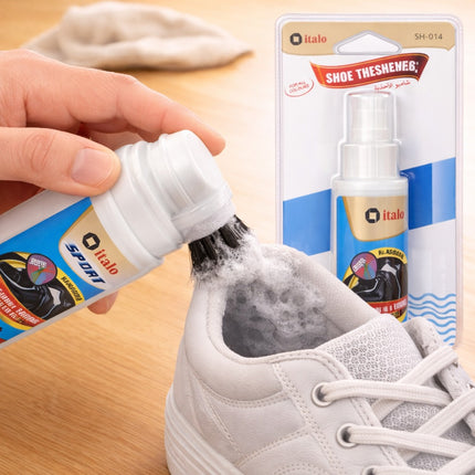 Person using a shoe shine spray on a white sneaker with italo branding.