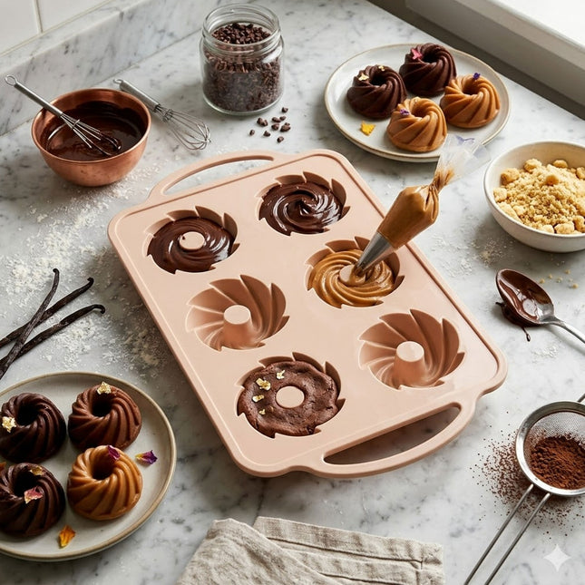 Bundt cake mold with chocolate and vanilla bundt cakes on a marble countertop.