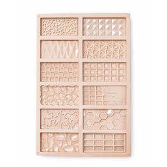Wooden mold with geometric patterns on a white background