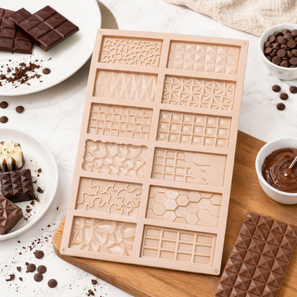 Silicone mold with various patterns on a wooden board surrounded by chocolate ingredients.