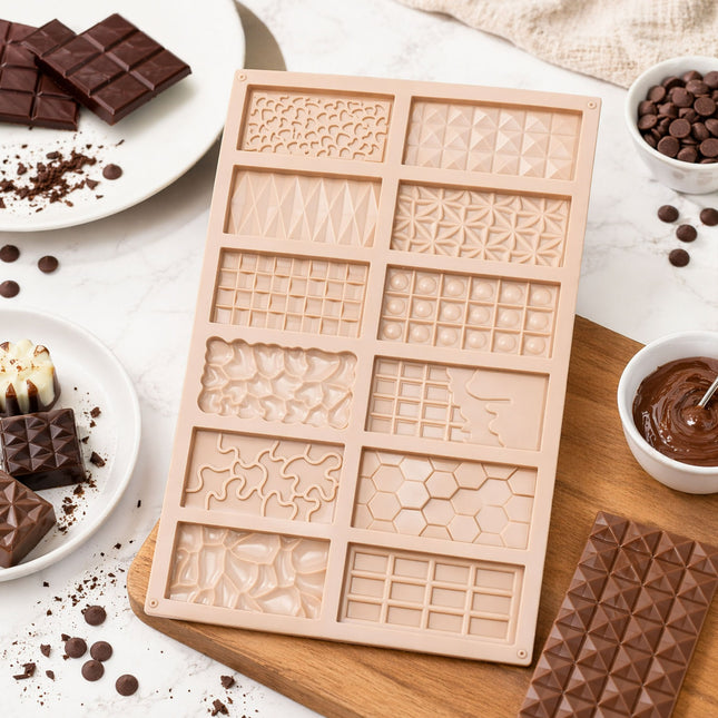 Silicone mold with various patterns on a wooden board surrounded by chocolate ingredients.