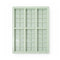 Light green silicone ice cube tray with grid pattern on a white background