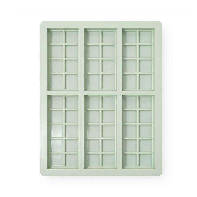 Light green silicone ice cube tray with grid pattern on a white background