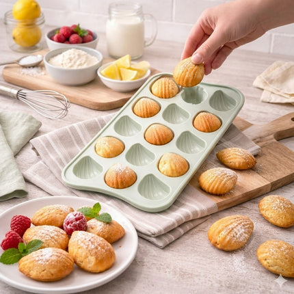 Person removing baked pastries from a green silicone mold on a kitchen counter.