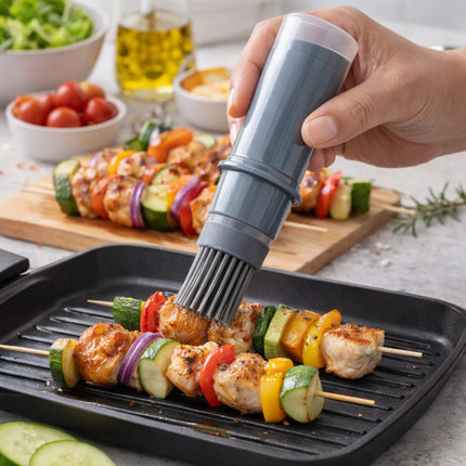 Person using a brush to apply sauce on skewered vegetables and chicken on a grill with a kitchen setting in the background.