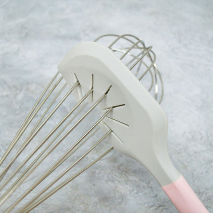 Gray whisk with pink handle on a light gray background
