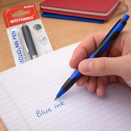 Hand holding a blue pen writing on paper with Motarro packaging in the background
