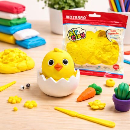 Yellow chick figure in an eggshell with Motarro Air Clay packaging on a wooden surface.