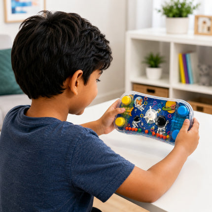 A child in a navy blue t-shirt holds a colorful, transparent sensory toy with astronaut and space-themed graphics and yellow buttons, set in a bright, modern room.