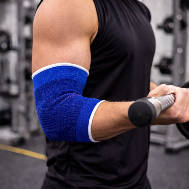 Person lifting weights with a blue elbow brace in a gym setting