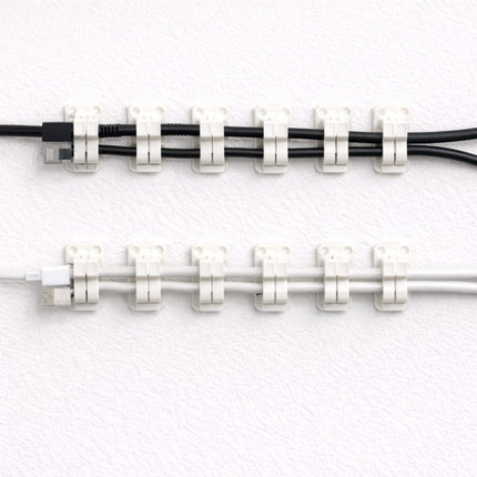 Cable ties holding two cables together on a white background