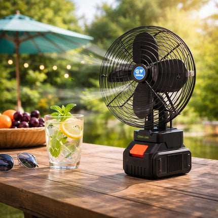 Portable fan on a wooden table with a drink and sunglasses, outdoor setting