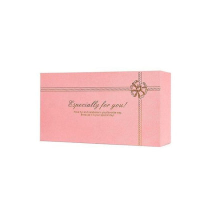 Pink gift box with a gold bow and text on a white background