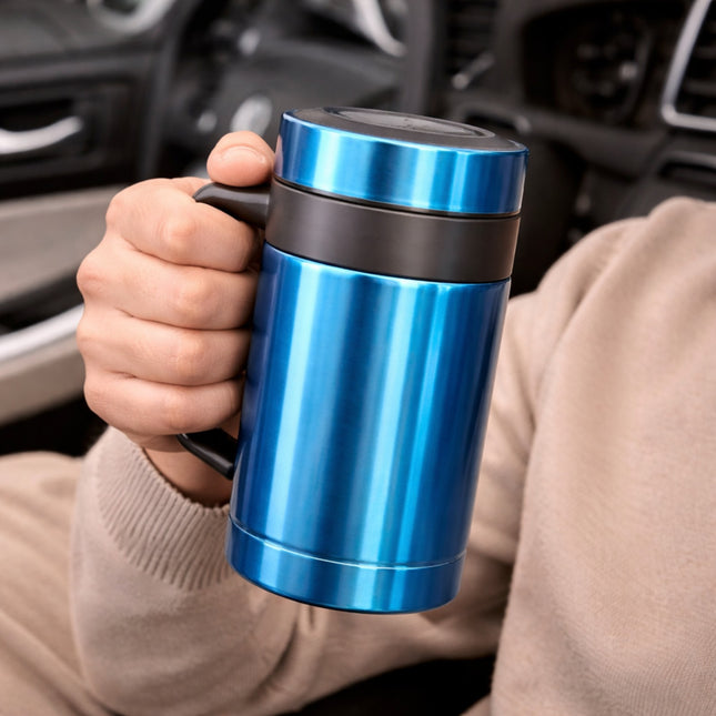 Hand holding a blue travel mug with a car interior in the background